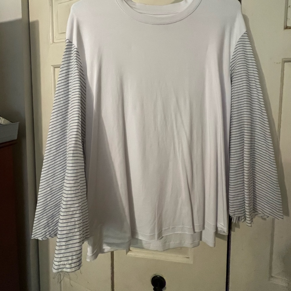 Bell sleeve top. Bought from a local boutique. Never worn. Fits like an XL